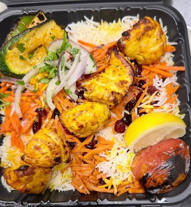Chicken kabob with seasoned rice.
